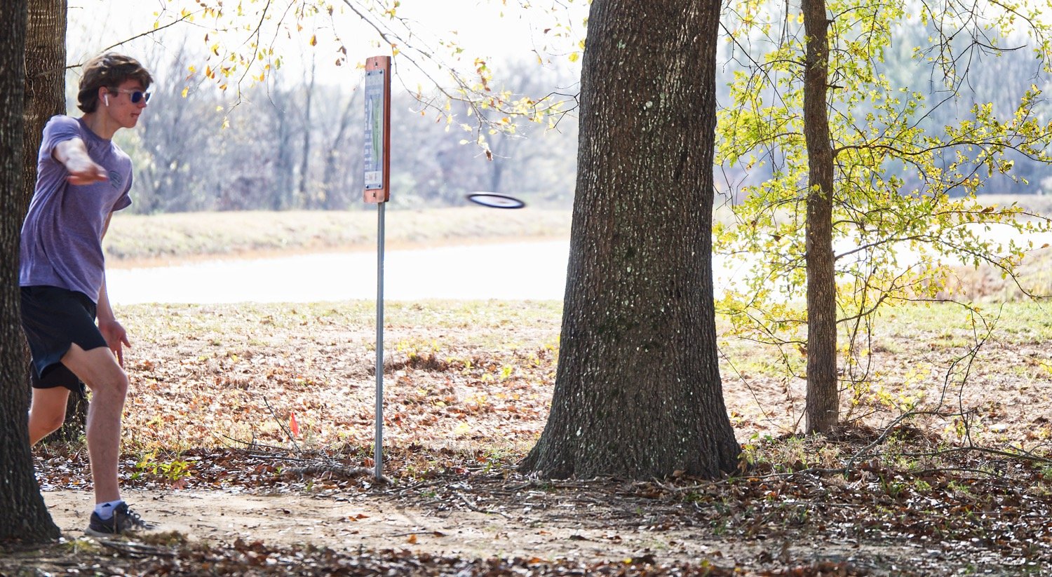 The tee on the second hole of The Preserve sits at the bottom a hill, overlooking a fishing pond, seen behind this thrower.
[see more shots or purchase prints]